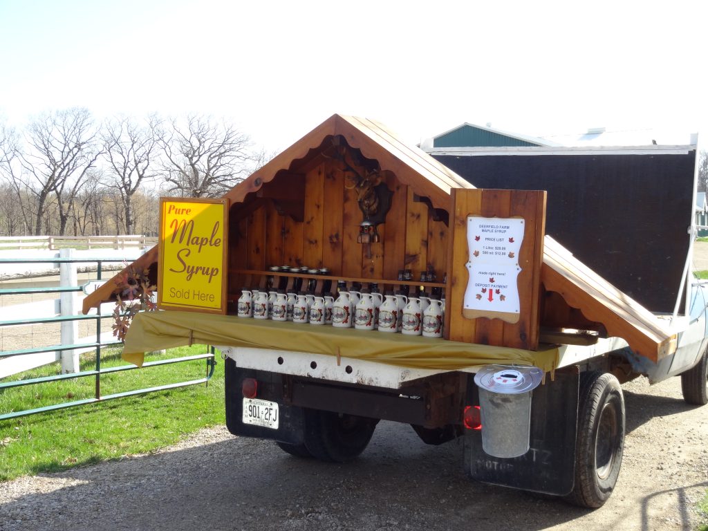 Deerfield Farm maple syrup displayed for sale at the farm gate